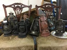 A large collection of old paraffin lamps.