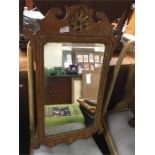 An Antique mahogany and gilt framed mirror.