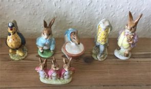 A group of six Beatrix Potter figures.