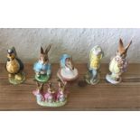 A group of six Beatrix Potter figures.