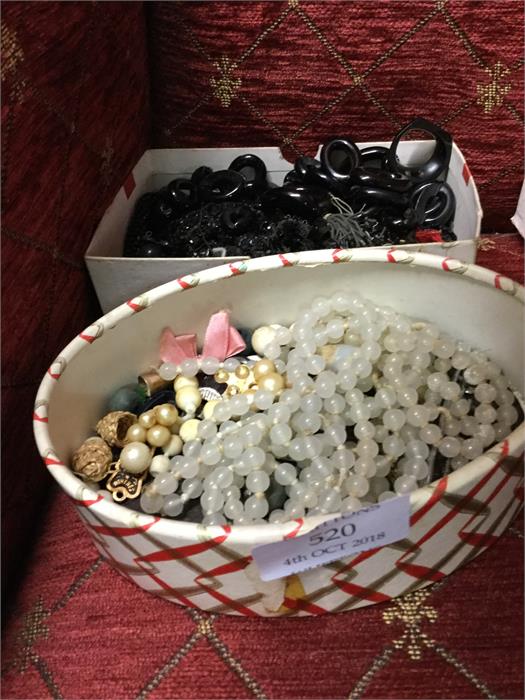 Two boxes of beads and other jewellery.