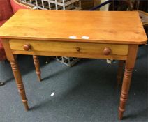 A single drawer pine table.