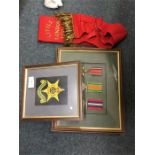 A framed and glazed collection of medals etc.