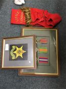 A framed and glazed collection of medals etc.