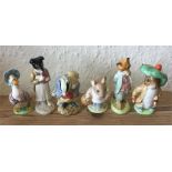 A group of six Beatrix Potter figures.