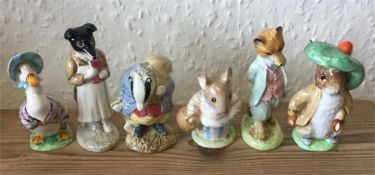 A group of six Beatrix Potter figures.