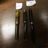 Three Parker pens.