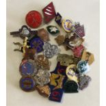 A group of girl guide and other brooches.