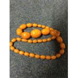 A graduated string of amber beads with concealed c