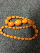 A graduated string of amber beads with concealed c