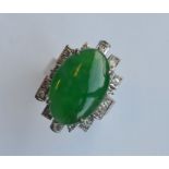 A heavy 18 carat jade and diamond modernistic ring