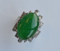 A heavy 18 carat jade and diamond modernistic ring