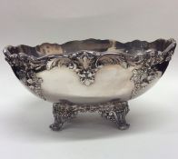 A large oval silver plated fruit dish heavily embo