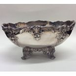 A large oval silver plated fruit dish heavily embo