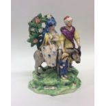 A rare early 19th Century Staffordshire group modelled as Joseph and Mary
