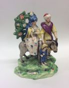 A rare early 19th Century Staffordshire group modelled as Joseph and Mary