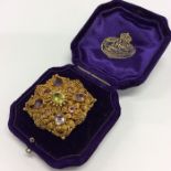 A good Antique brooch inset with amethyst and fili