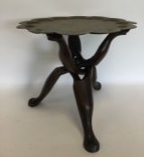 A Continental brass mounted tripod table engraved