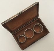 A silver engine turned cigarette box together with