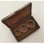 A silver engine turned cigarette box together with