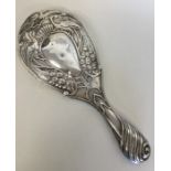A good silver embossed hand mirror mounted with pe
