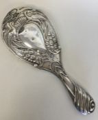 A good silver embossed hand mirror mounted with pe