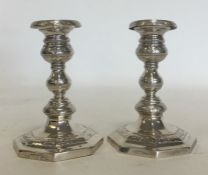 A pair of Continental silver dwarf candlesticks at