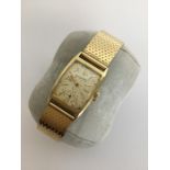 TIFFANY: A gent's 14 carat wristwatch with silvere
