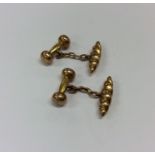 A pair of gold torpedo shaped cufflinks. Approx. 3