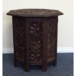 A good oak carved table attractively decorated wit