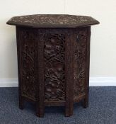 A good oak carved table attractively decorated wit