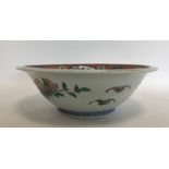 A large Chinese bowl decorated with animals and le