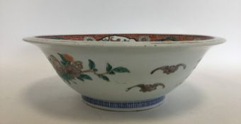 A large Chinese bowl decorated with animals and le