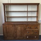 A large pine dresser with plank top and cupboard b