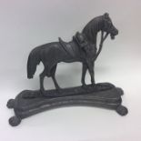 An Antique pewter doorstop in the form of a horse