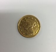 A 1906 USA gold coin. Est. £80 - £120.