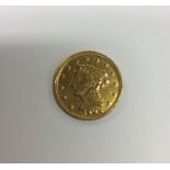 A 1906 USA gold coin. Est. £80 - £120.