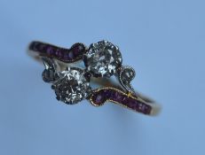 A ruby and diamond crossover ring in 18 carat gold