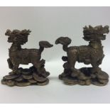 A pair of heavy bronze figures of dragons with tex
