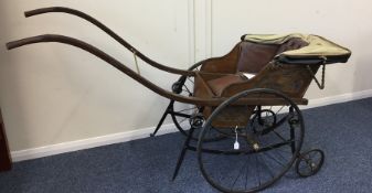 A unusual Victorian child's pram with spoked wheel