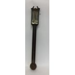 A mahogany stick barometer with silvered dial. By