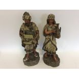 A pair of large pottery figures on rugged bases. A