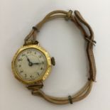 A lady's gold wristwatch with white enamelled dial