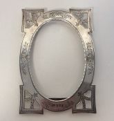 A silver bright cut picture frame decorated with f