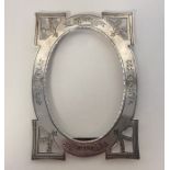 A silver bright cut picture frame decorated with f