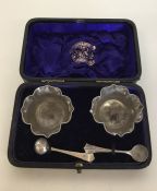 A boxed pair of silver salts together with matchin