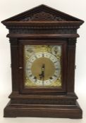 A heavy Edwardian oak cased mantle clock with stri