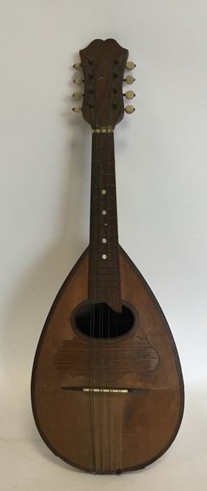 An old maple mandolin. Est. £20 - £30.