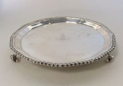 A small Edwardian silver waiter with gadroon rim.