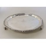 A small Edwardian silver waiter with gadroon rim.